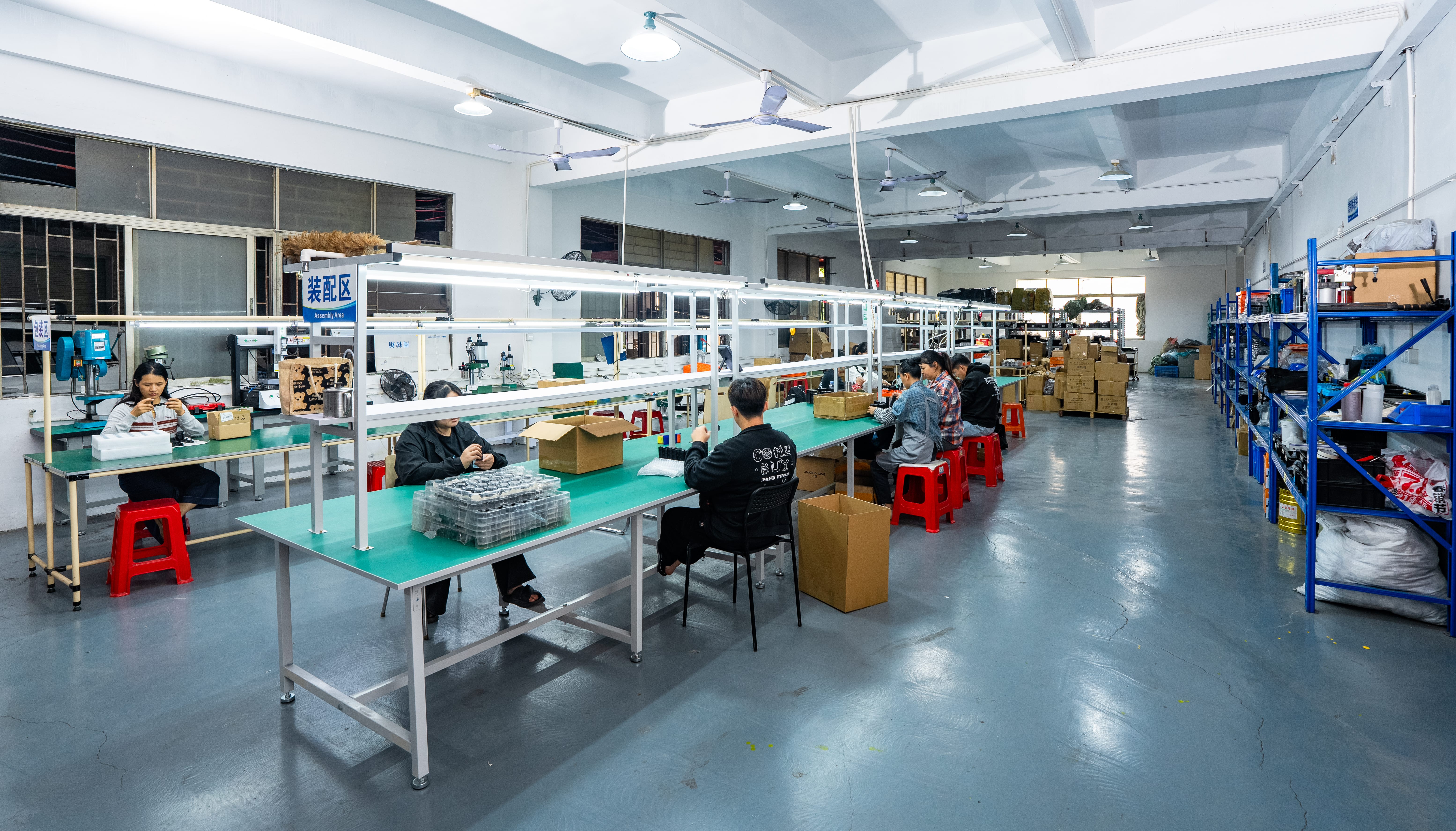 Wide view of the OGLemon team assembling components on the production floor